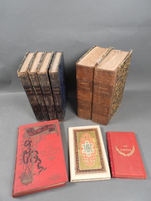 several books are stacked on top of each other on a table