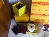 a yellow box with a camera and a pair of sunglasses