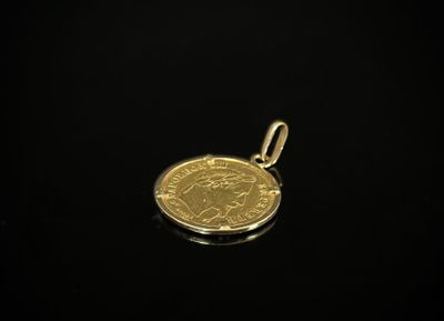 Une pièce d'or est représentée sur une surface noire.