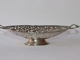 an antique silver plated bowl on a stand on a white background