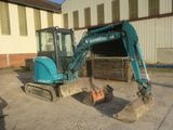a small excavator that is sitting in the dirt