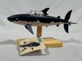 a toy shark with a man in a boat on top of it