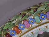 a close up of a decorative vase with flowers on it