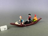 figurines of three people in a boat with a number 7 on the side