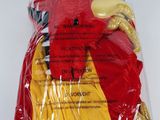 a red and yellow stuffed animal in a plastic bag