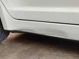 a close up of a white car with a flat tire