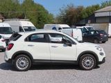 a white car parked in a parking lot with other cars in the background