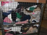 a metal cart with a bunch of stuffed animals inside of it