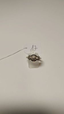a small piece of jewelry on the table