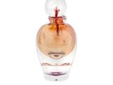 a small glass bottle with a red flower inside of it