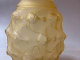 a yellow vase sitting on a table with a white background