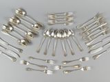 a lot of silver spoons and forks arranged in a circle