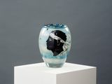 a glass vase with a picture of a person on it