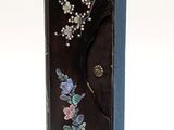 a black box with flowers on it on a white background