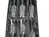 four wine glasses in a black box with a black ribbon