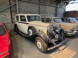 several old cars are parked in a garage next to each other