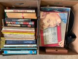 a cardboard box full of books and a phone