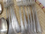 a lot of silver spoons and spoons on a tray