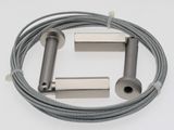 a close up of a cable and a metal tube on a white surface