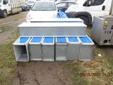 a lot of metal boxes that are sitting in the dirt