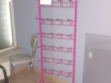 a pink shelf with a lot of items on it