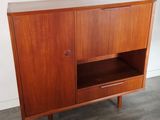 a close up of a wooden cabinet with a shelf on it