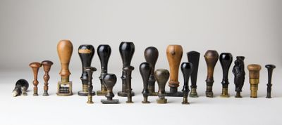 a lot of different types of wooden mallets on a white surface