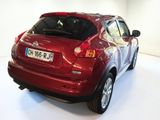 a red car that is parked in a white room