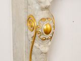 an image of a white marble fireplace with a lion head on the mantle