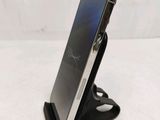 a close up of a cell phone on a stand on a table