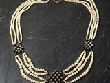 three strand pearl necklace with black and white beads