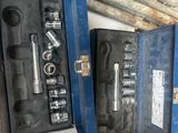 a man holding a tool box with tools in it