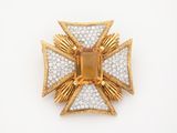 an image of a gold and diamond cross broochle