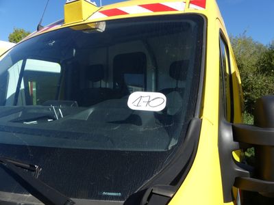 a close up of a yellow truck with a sign on the windshield