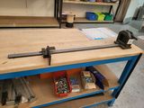 a clamp on a workbench in a workshop