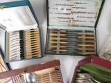 many different types of spoons and forks in a box