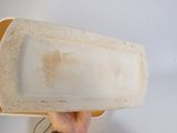 a person holding a white plate with dirt on it