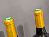 three wine bottles that are sitting on a table