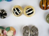 many different types of jewelry on a white surface