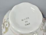 a close up of a vase with a lid on a table