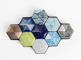 Plusieurs hexagones de différentes couleurs sont disposés selon un motif hexagonal.