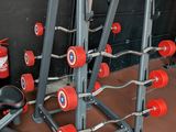 a gym equipment set up in front of a black wall