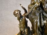 a bronze statue of a man and a child