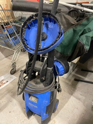 un aspirateur bleu et noir et un caddie à l'arrière-plan