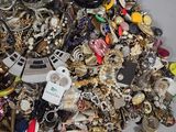 a pile of assorted jewelry sitting on a table