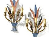 pair of wall sconces with colorful feathers on each of them