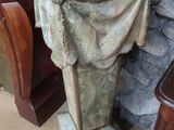 a stone pedestal with a cloth draped over it in a room