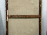 an old wooden frame sitting on the floor in front of a white wall