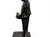 statue of a boy with a bird in his hand on a marble base
