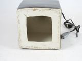 a small white microwave oven with a power cord attached to it